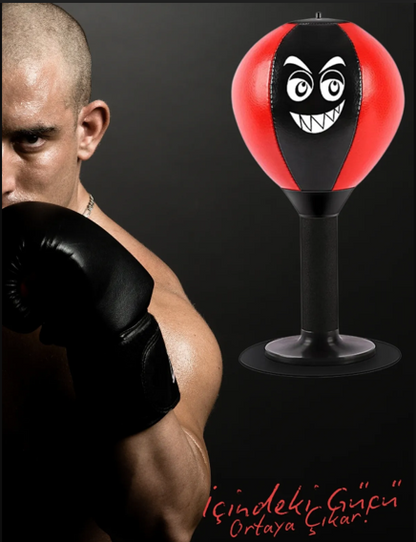 Person wearing boxing gloves with a punching bag featuring a face design.